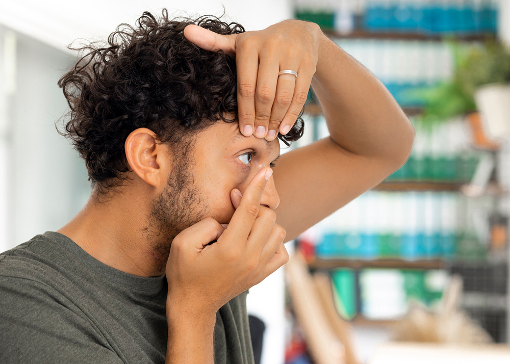 Man putting in his contact lens