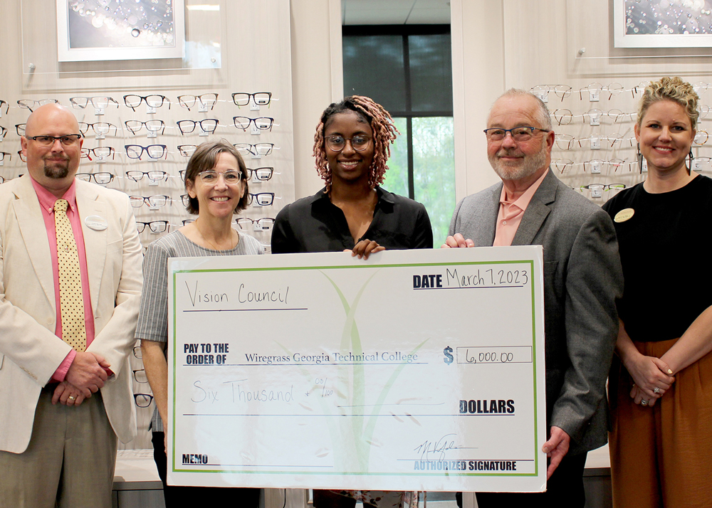 Scholarship recipient with giant check