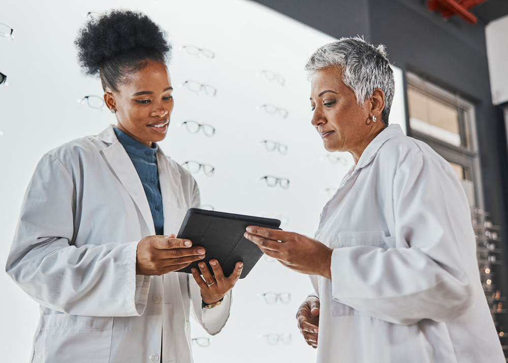 2 optometrists looking at a tablet