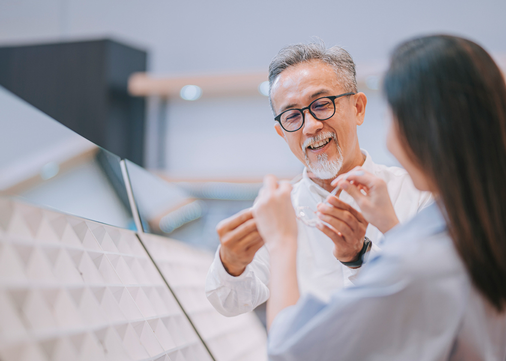 Man and woman looking at glasses