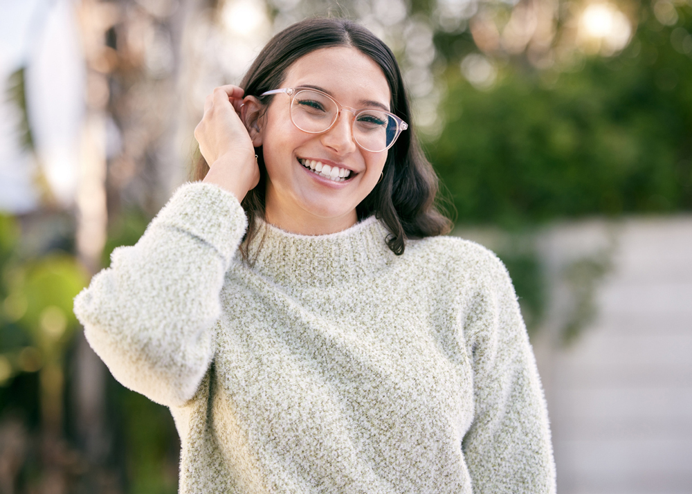 Young woman wearing glasses and smiling