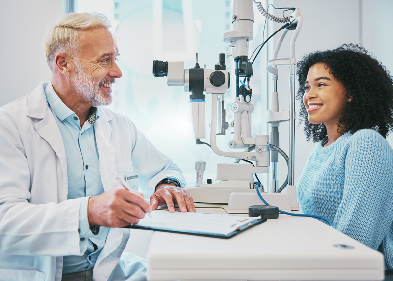 Optometrist talking with patient